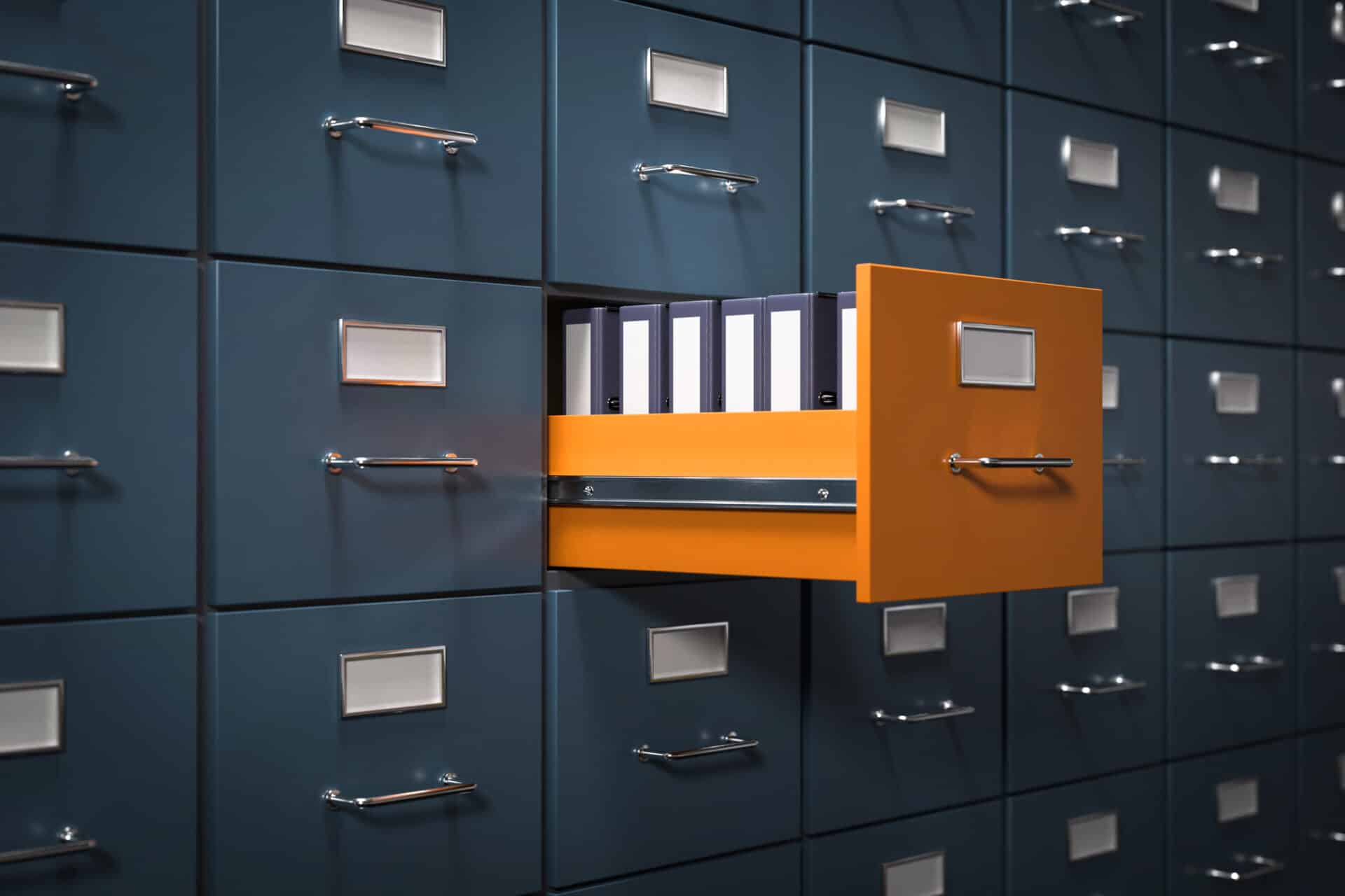 A drawer wall for documents, one drawer stands out in color and is open, containing files